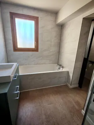 a bathroom with a bath tub and a window at Villa provençale Les Agapanthes in Saint-Saturnin-les-Apt