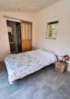 a bedroom with a bed and a window at Le Jardin du Félibrige in Lançon-Provence