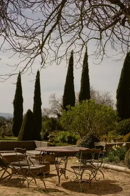 a picnic table and chairs in a park with trees at Grand Cèdre in Aix-en-Provence
