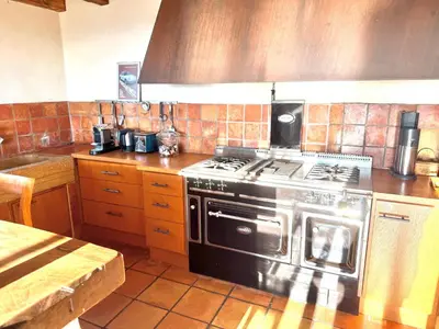 a kitchen with a stainless steel stove top oven at cheznico jas d la plane in Bédoin