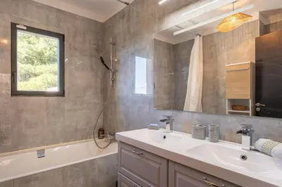a bathroom with a sink and a tub and a mirror at Aria Blue - Spacieuse - Climatisée - Piscine in Lançon-Provence