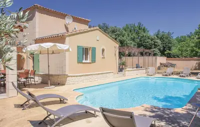 a swimming pool with chairs and a house at Awesome Home In Saint Didier in Saint-Didier