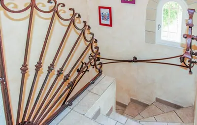 a spiral staircase with a metal railing in a house at Awesome Home In Saint Didier in Saint-Didier