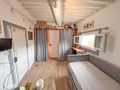 a small room with a bed and a window at Studio coeur de ville, rue Papassaudi in Aix-en-Provence
