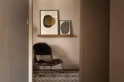 a room with a chair and two pictures on the wall at Maison Rosalie in Carpentras