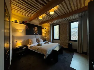 a bedroom with a large bed in a room at Auberge Nostradamus, Appartement 2 in Salon-de-Provence