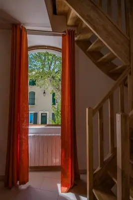 an empty hallway with a table in a house at Maison de village au cœur d'Eyguières Alpilles in Eyguières