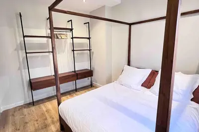 a bedroom with a four poster bed and a book shelf at La Terrasse, 2 chambres, hyper centre in Aix-en-Provence
