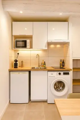 a kitchen with a washing machine and a microwave at Cozy et elegant studio Aix en Provence centre in Aix-en-Provence