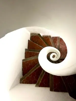 a spiral stair case with a spiral staircase at Cozy et elegant studio Aix en Provence centre in Aix-en-Provence