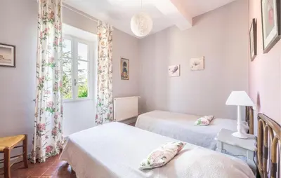a bedroom with two beds and a window at Maison De Charme in Jonquerettes