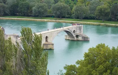 a group of people crossing a bridge over a river at Maison De Charme in Jonquerettes