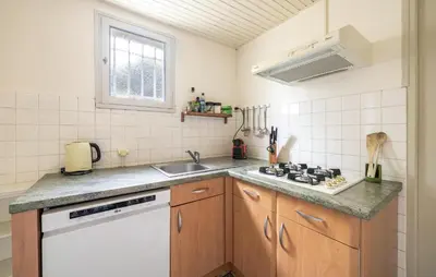a kitchen with a sink and a stove at Maison De Charme in Jonquerettes