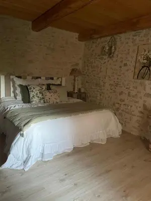 a bedroom with a white bed in a room at Domaine de la barbeirasse in Céreste