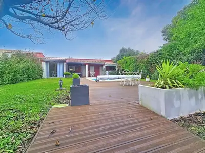 a wooden deck in a yard with a house at Tiny house Cécile en Avignon in Avignon