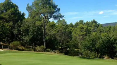 a golf course with trees and a green field at Charming house, Lubéron, near golf and wineries in Pierrevert