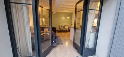 a view of a room with sliding glass doors at Charming village house in Éguilles
