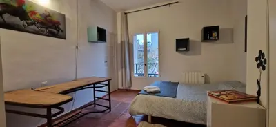 a small living room with a bed and a table at Charming village house in Éguilles
