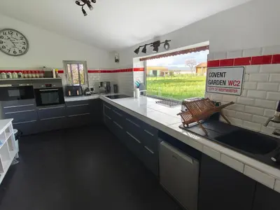 a kitchen with a sink and a window with a sign at mas alpilles in Eyguières
