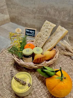 a basket of bread and other foods on a table at Perle Aix en Provence centre ville in Aix-en-Provence