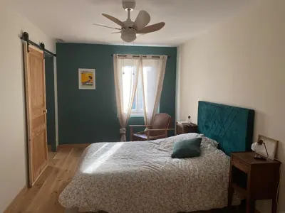 a bedroom with a bed and a ceiling fan at Casa Poli, maison de village avec terrasse in Eyguières