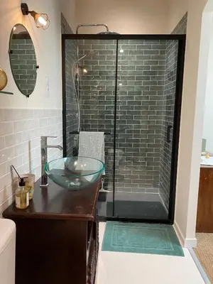 a bathroom with a glass sink and a shower at Casa Poli, maison de village avec terrasse in Eyguières