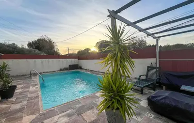 a swimming pool with a chair and a palm tree at Awesome Home In Miramas With Swimming Pool in Miramas