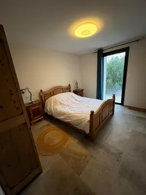 a bedroom with a large bed and a window at La propriété de Nans in Grans