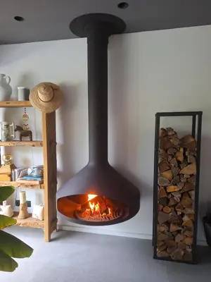 a fireplace in a room with a pile of logs at Villa 5 étoiles, 6 personnes in LʼIsle-sur-la-Sorgue