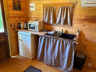 a kitchen with a counter with a microwave and a sink at Chicken roulotte des 3 cèdres in Cavaillon