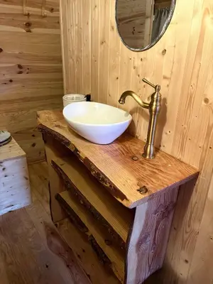 a bathroom with a sink and a mirror on a wooden counter at Chicken roulotte des 3 cèdres in Cavaillon
