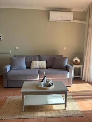 a living room with a couch and a coffee table at Appartement domaine de Pont Royal in Mallemort