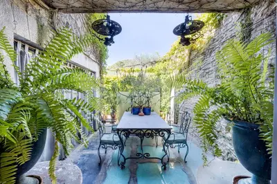 a patio with a table and chairs and plants at Signature Home Pool & Panoramic Terrace in Goult