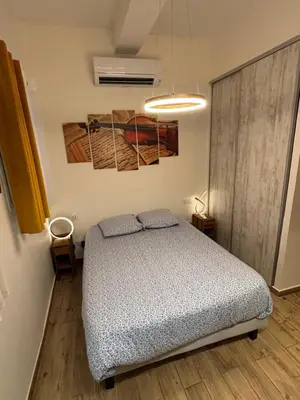 a bedroom with a bed and a painting on the wall at Appartement Turandot, 1 chambre, près du Cours Mirabeau in Aix-en-Provence
