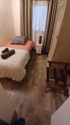 a bedroom with two beds and a wooden floor at Appartement Lotus Rouge, 2 chambres, proche Mairie in Aix-en-Provence