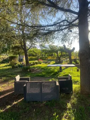 a park with a picnic table and a tree at La Roussillonnaise in Roussillon