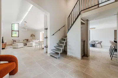 a living room with a staircase leading to a living room at Magnifique villa au coeur de la campagne de Gordes in Gordes