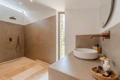 a bathroom with a white sink and a shower at Magnifique villa au coeur de la campagne de Gordes in Gordes