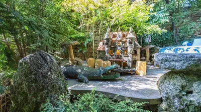 a garden with a iguana statue and a house at Romantic Provence Pool & Mill View in Goult