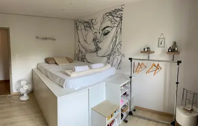 a bedroom with a bed and a painting on the wall at mas de la bergerie in Cavaillon