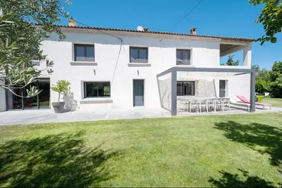 a white house with a lawn in front of it at mas de la bergerie in Cavaillon