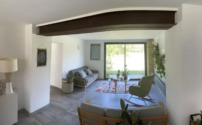 a living room with a couch and a table at mas de la bergerie in Cavaillon