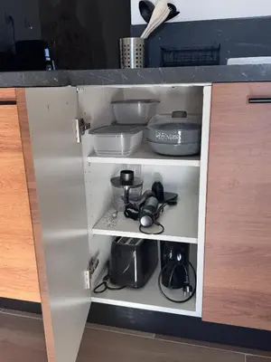 a cupboard filled with dishes and other kitchen items at Studio Rénové de Charme en Provence in Caumont-sur-Durance