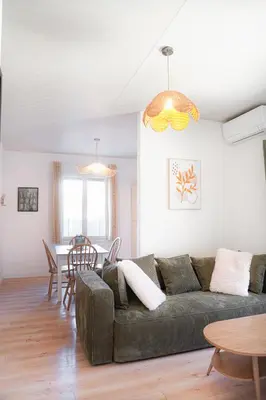 a living room with a couch and a table at L Appartement 1 Chambre - Gîte la Bergerie du Ventoux in Mormoiron