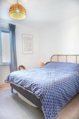 a bedroom with a bed with a blue comforter at La Maison Duplex 3 Chambres - Gîte La Bergerie du Ventoux in Mormoiron