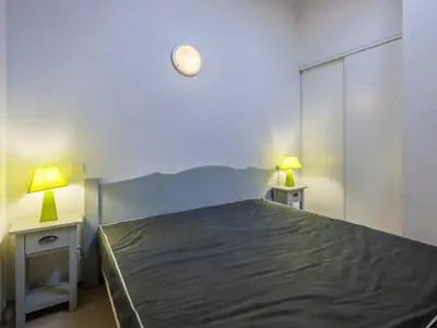 a bedroom with a bed and two lamps on two tables at D du Ventoux D N55 3P6 in Aubignan