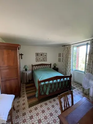 a bedroom with a bed and a window at Pierre Jacques' House in Caromb