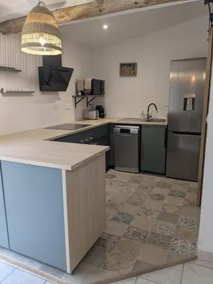 a kitchen with a counter and a refrigerator at Le gîte du domaine de Sinaca Villa in Sénas