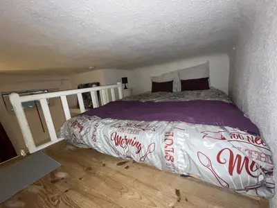 a bed in a small room with at Joli appartement atypique dans le centre d'Aix in Aix-en-Provence