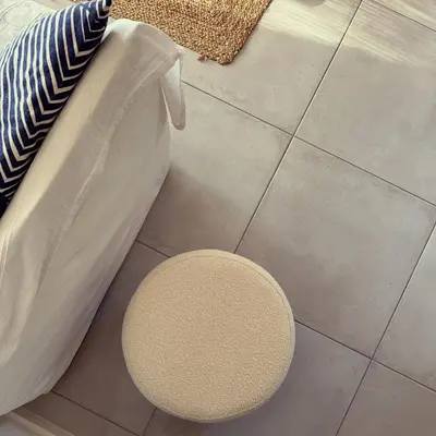 a stool sitting on the floor next to a bed at Superbe mas provençal avec piscine dans le Luberon in Lagnes